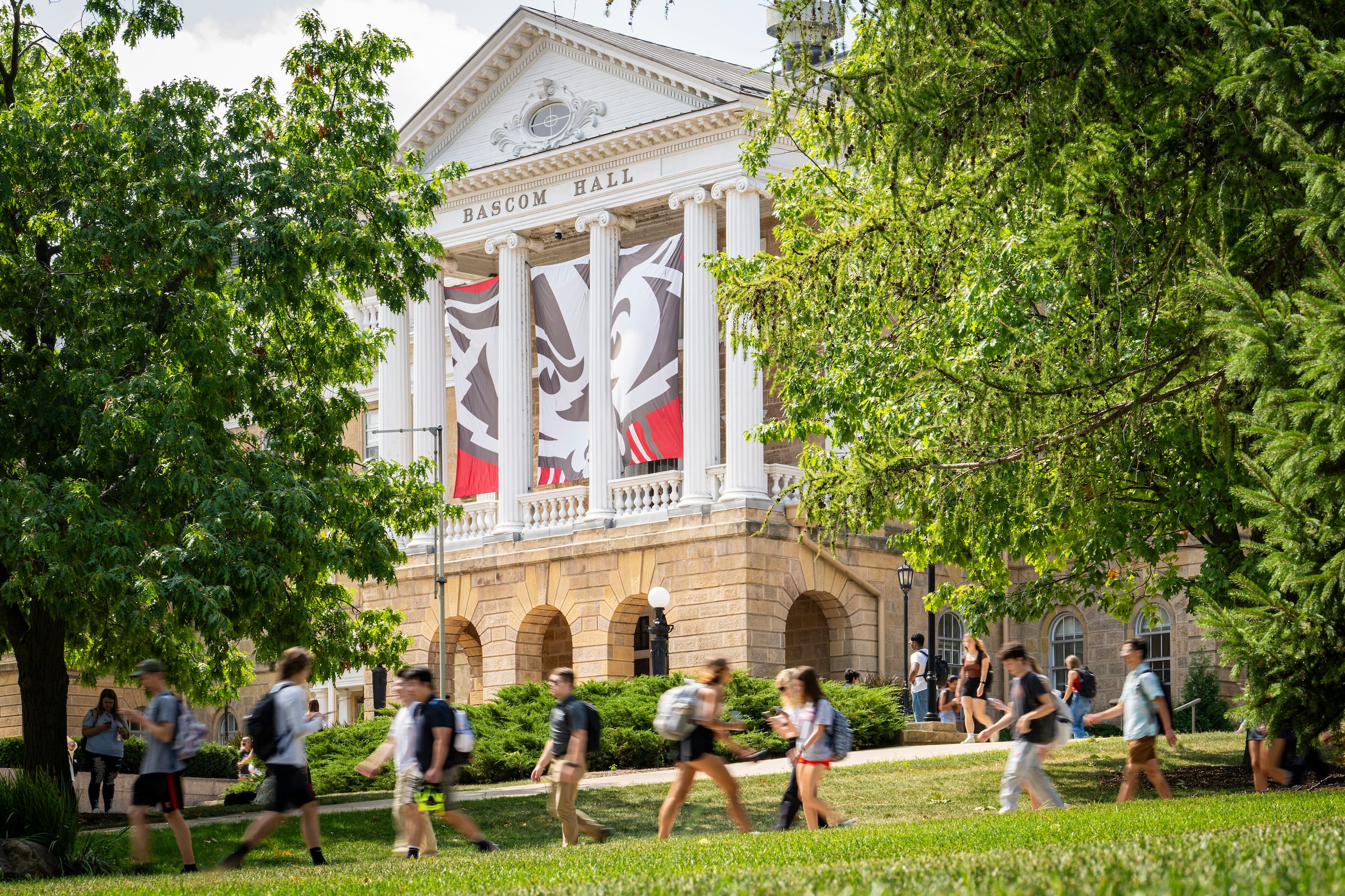 Students walking on Bascom Hill on a beautiful summer day