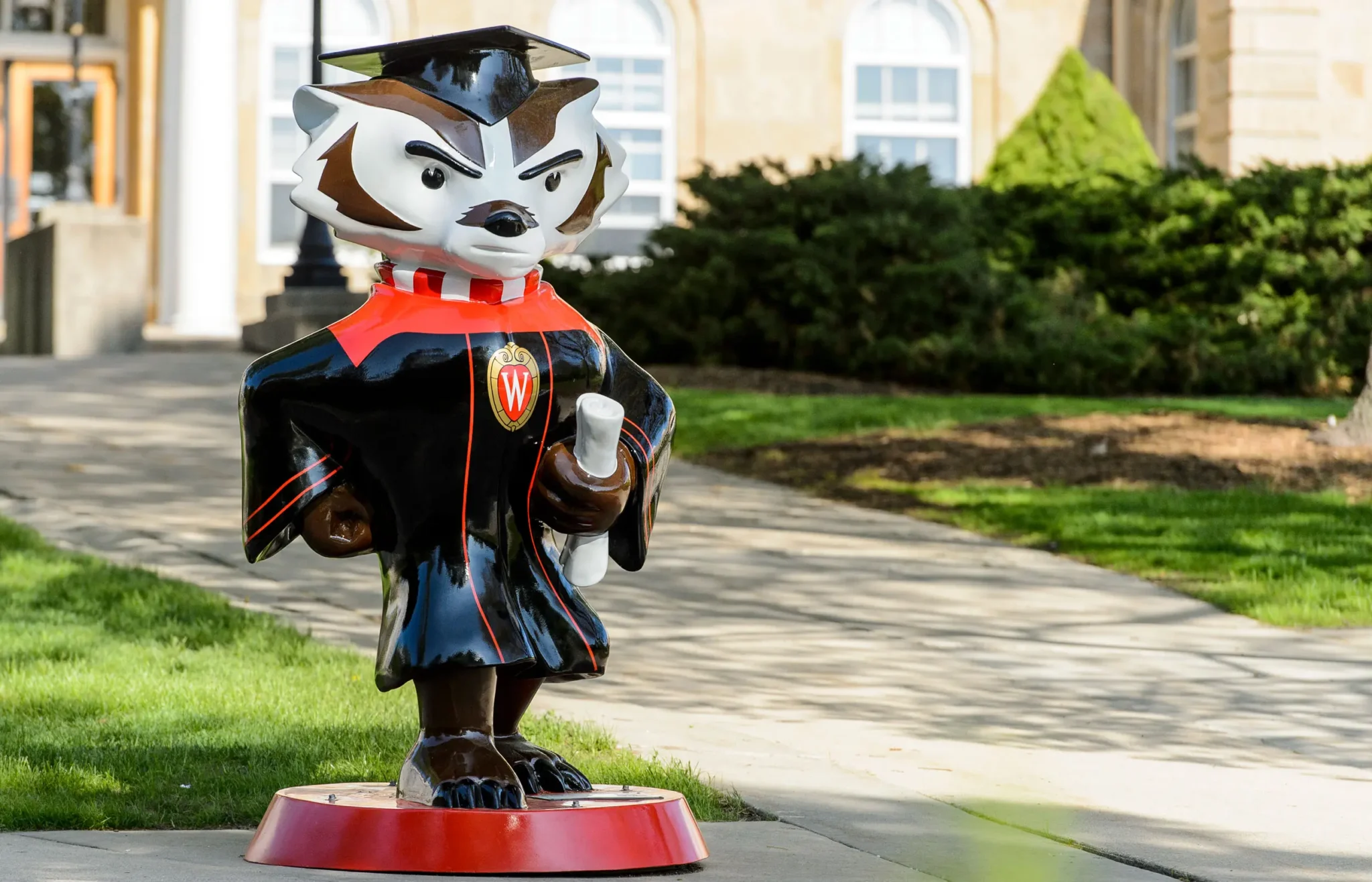 A statue of Bucky Badger outside a school building