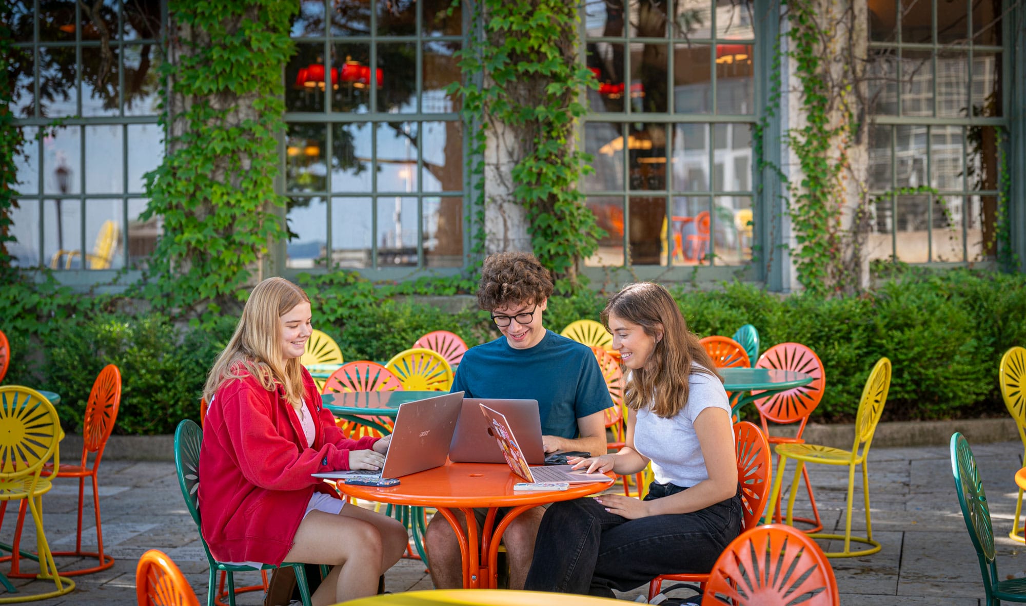 Students working on laptops on the terrace of the Memorial Union