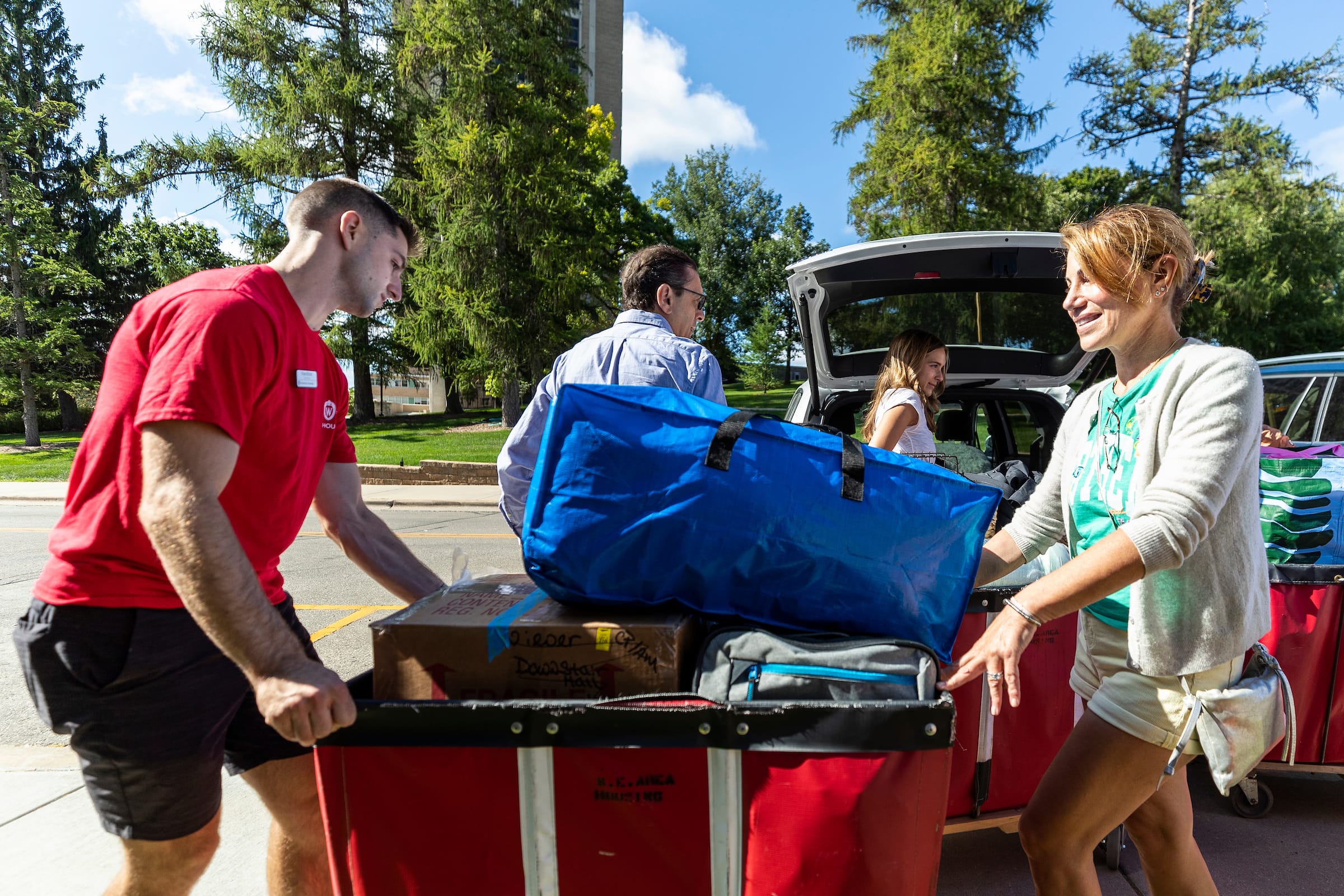 Students working with Housing employees and their families to move onto campus