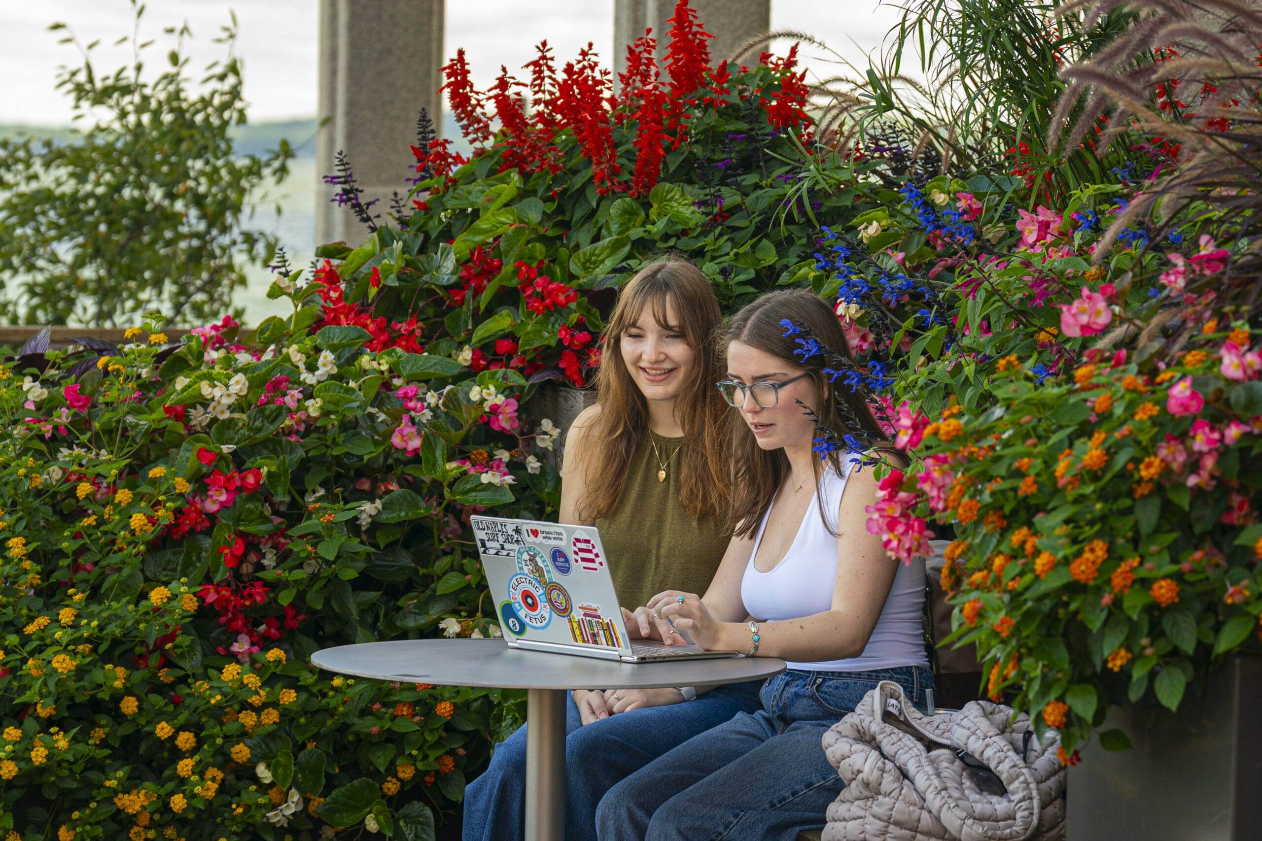 Students studying surrounded by flowers