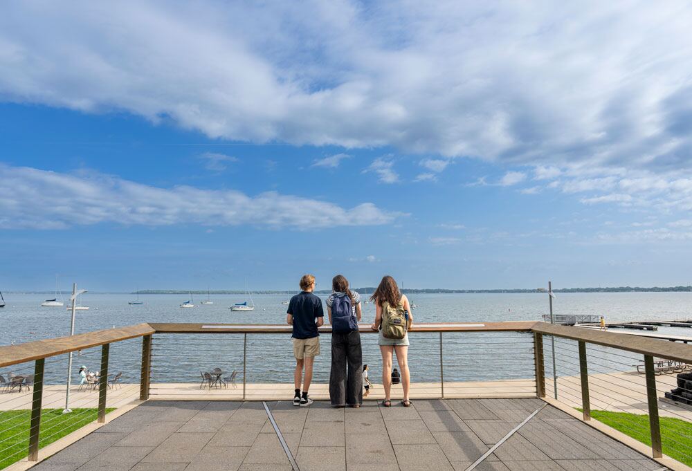 Three student looking out on Lake Mendota on a beautiful summer day