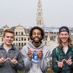4 UW students do the W hand sign in Brussels