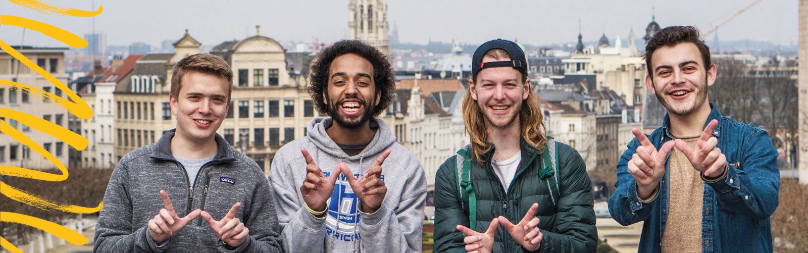 4 UW students do the "W" hand sign in Brussels