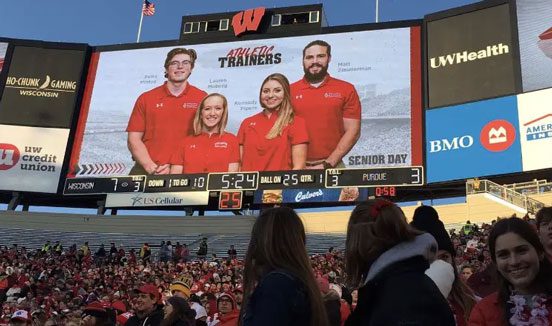 Advertisement for athletic trainers at a sports game