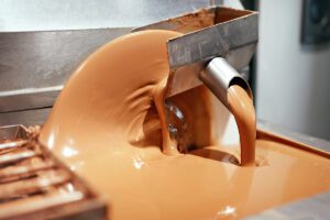 A machine pouring out liquid chocolate