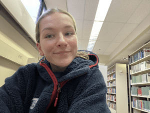 Kate Lewicki in the library smiling