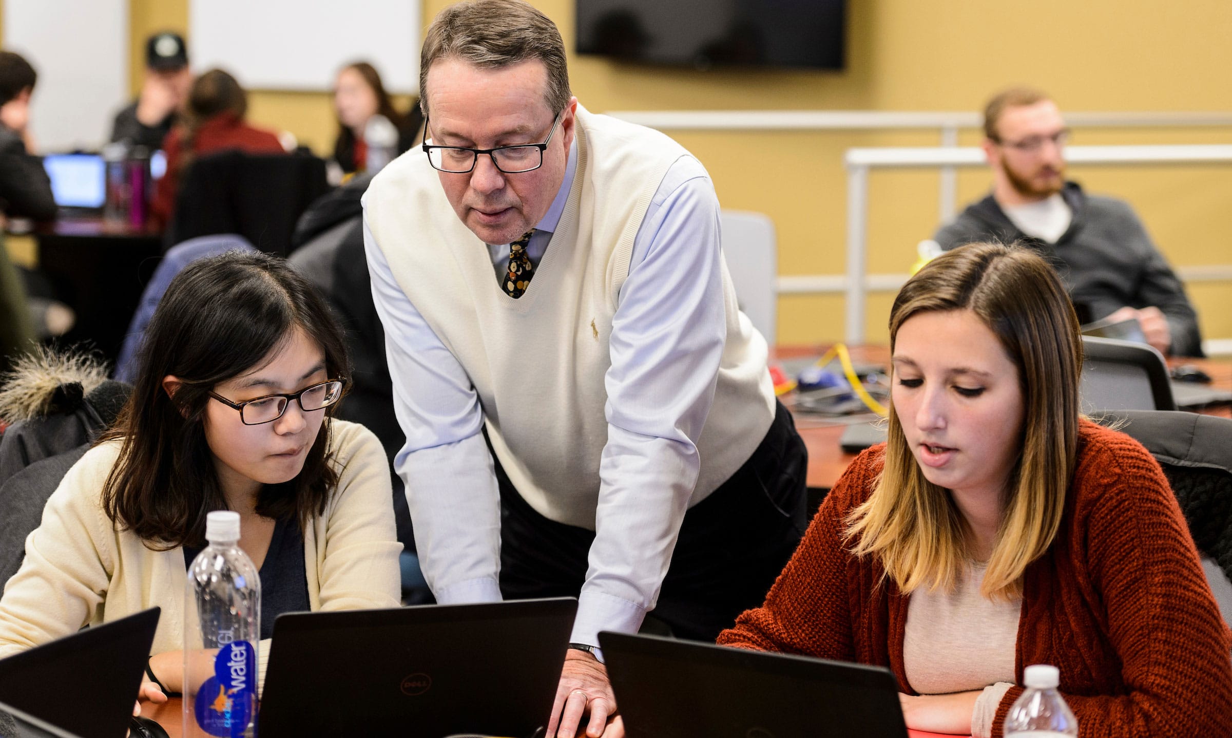 Professor speaking with students in an Accounting Finance class