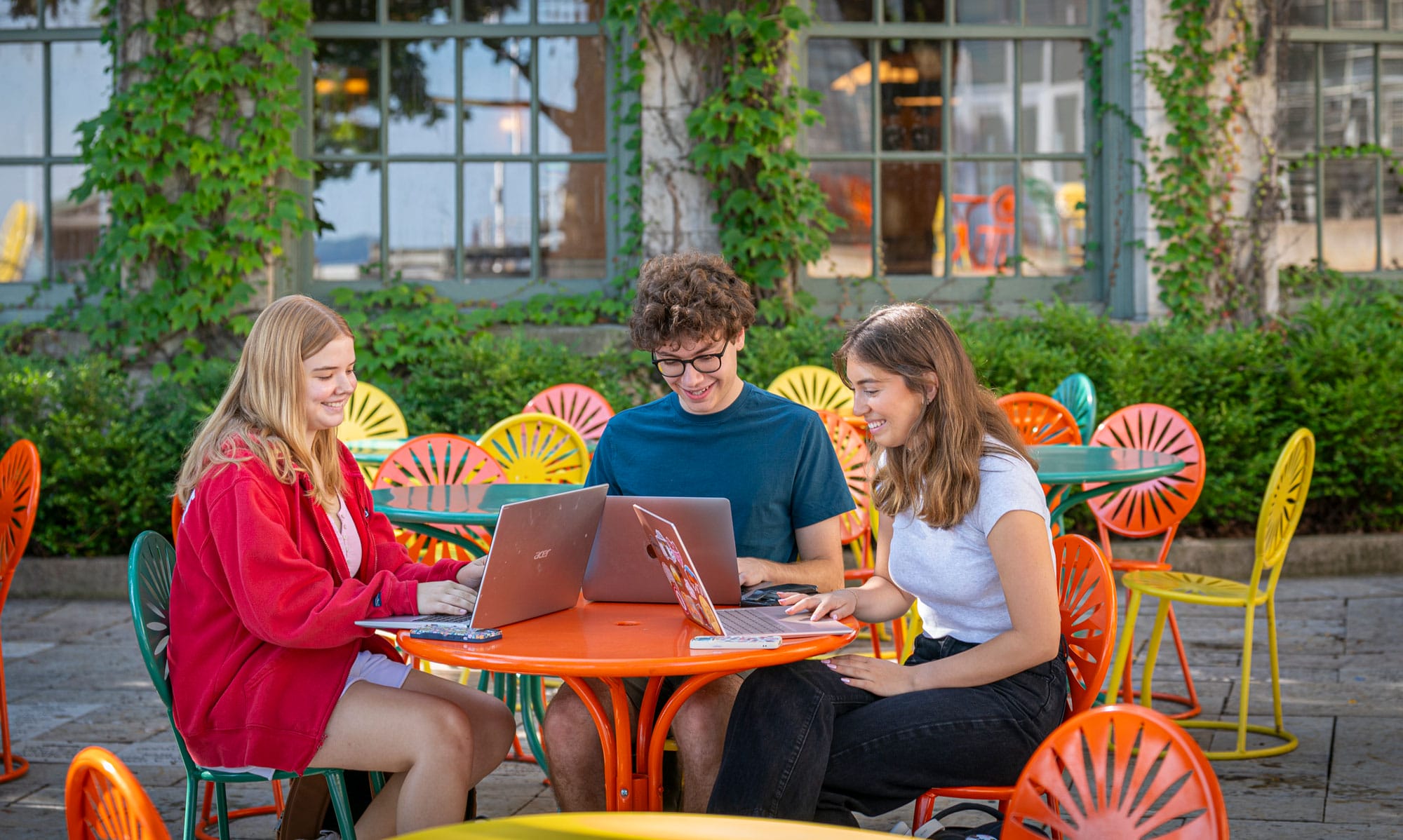 Students working on online class assignments on the Memorial Union Terrace