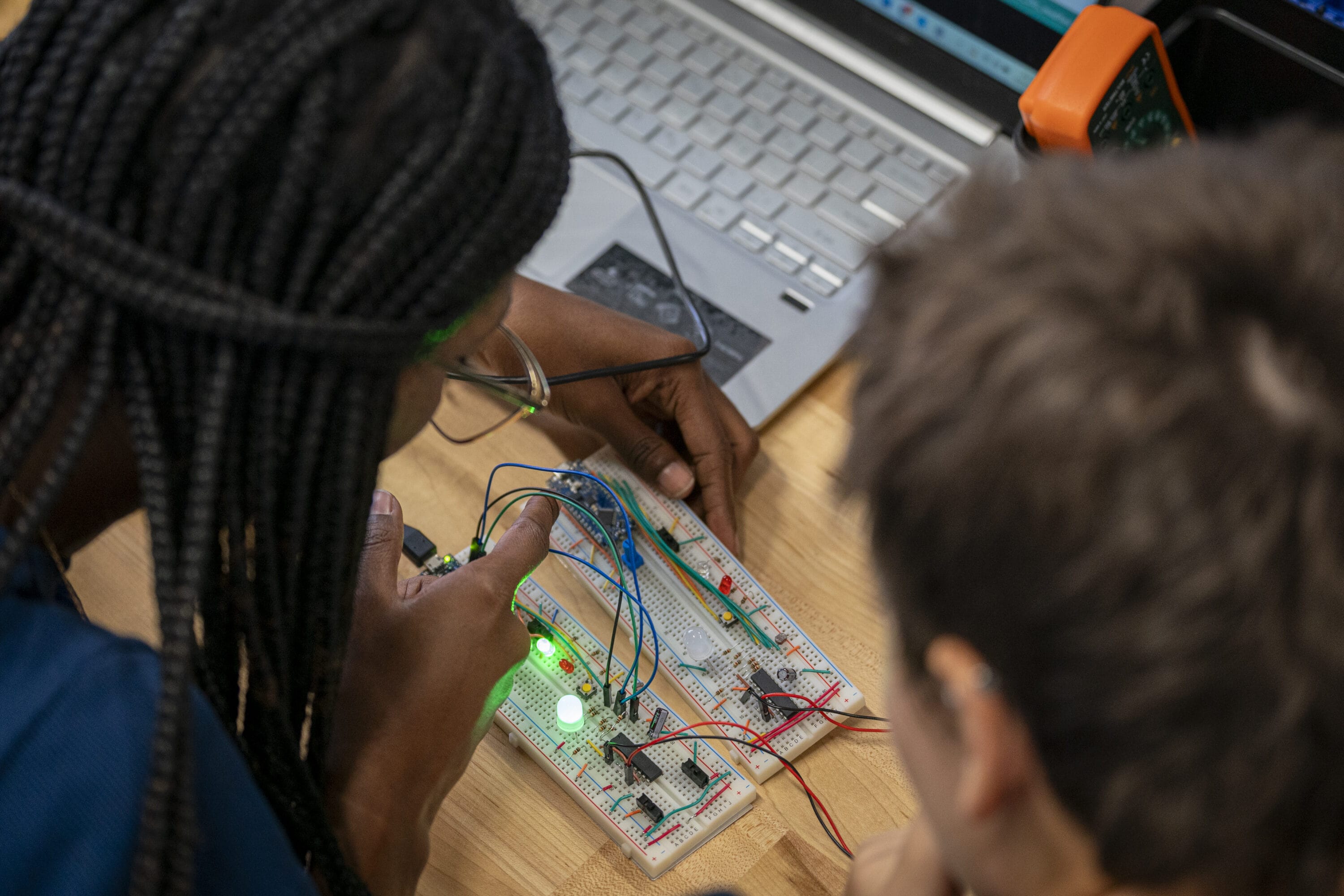 A pair of students working on a circuit.