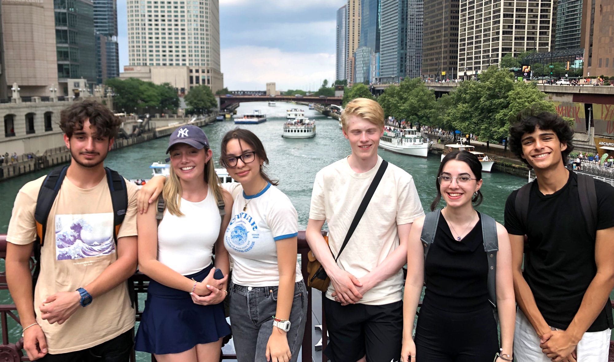 Six students posing for a group photo in front of a river.