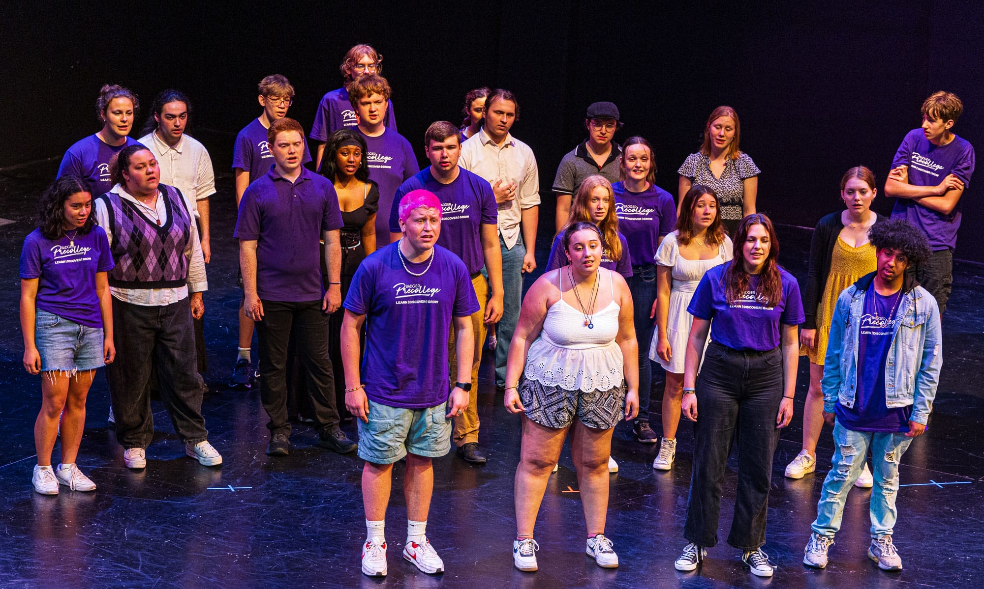 A group of high school music students posing for a group photo.