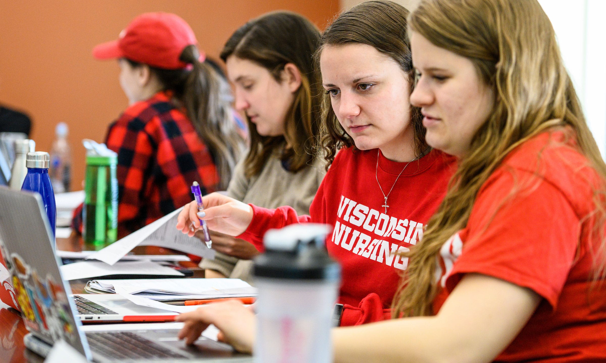 Students comparing notes in class