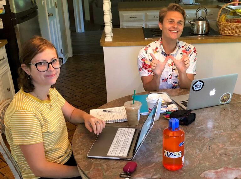 students studying with laptops at kitchen table