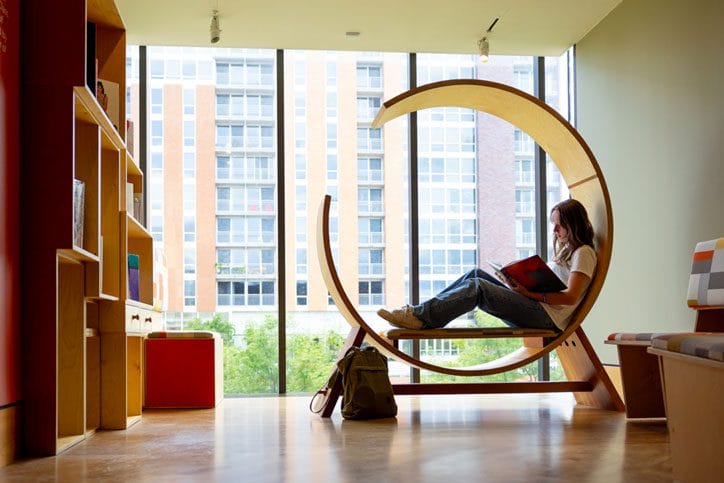 student studying in sunny spot in art museum