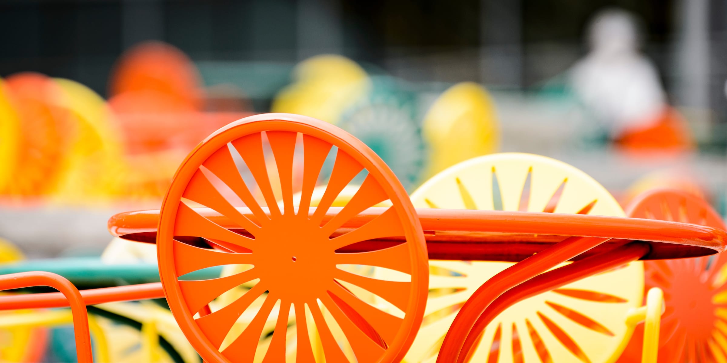 A close-up shot of orange and yellow terrace chairs.