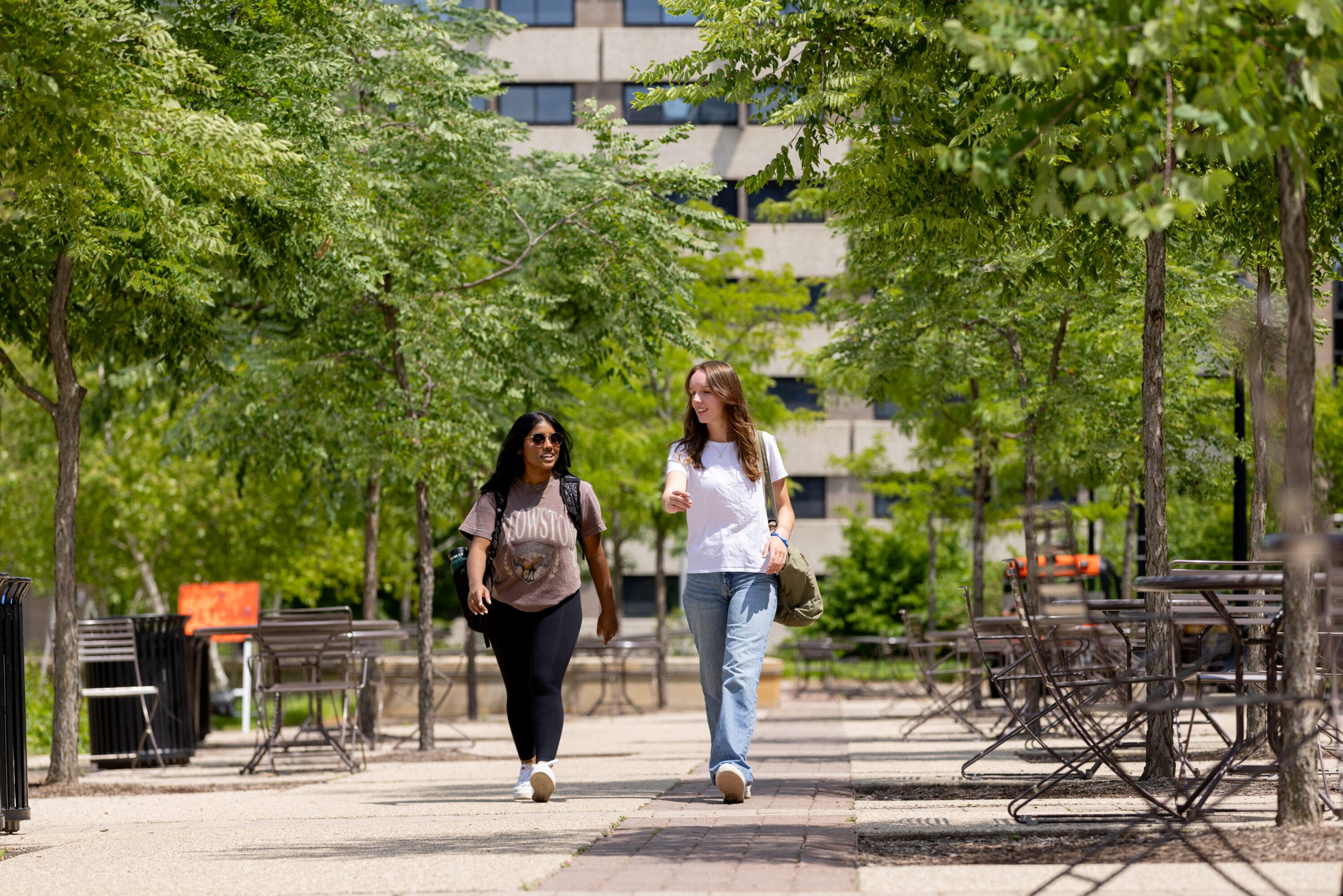 Two students walking on a summer day.