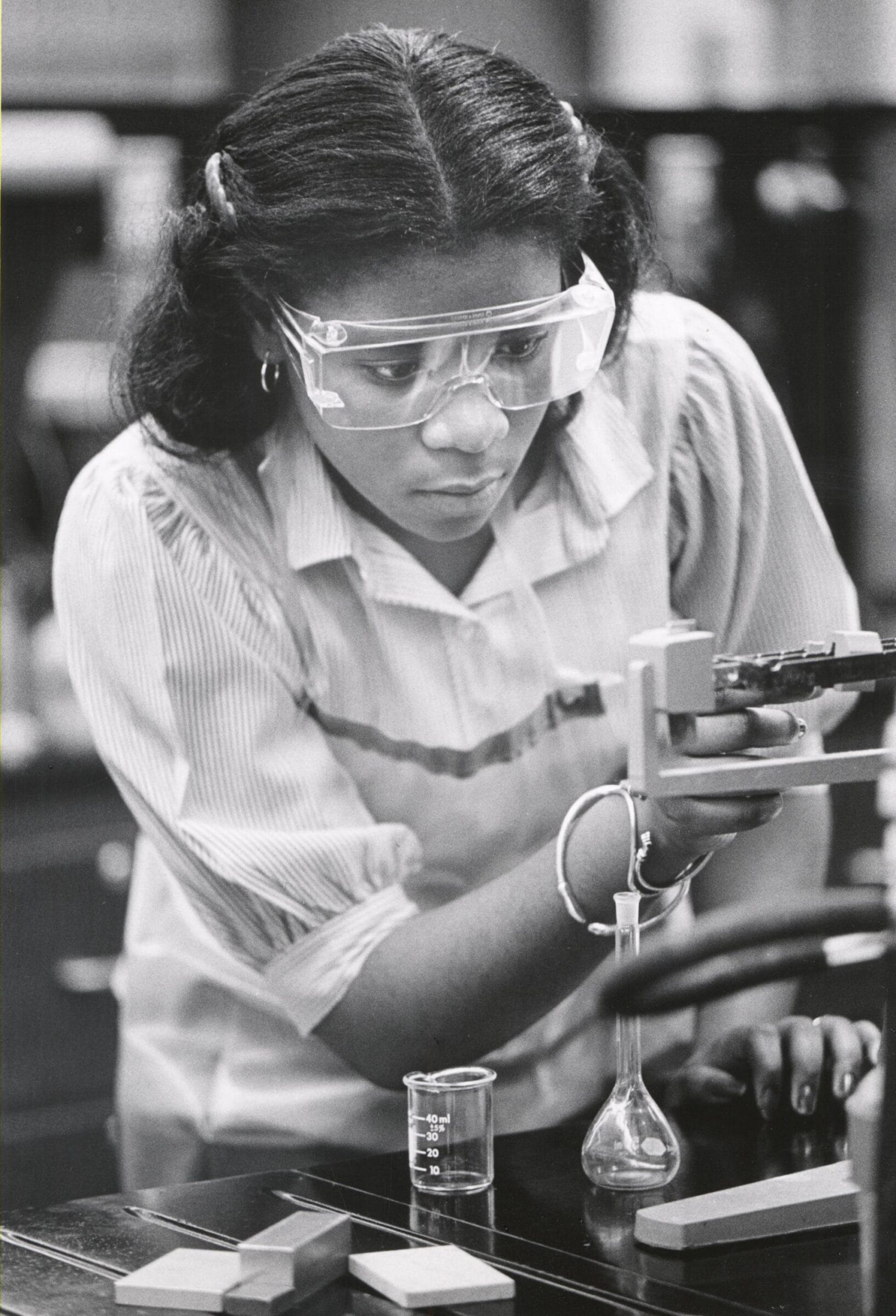 Cassandra Johnson, a UW-Madison student, weighing a specimen on a laboratory scale during a chemistry session.
