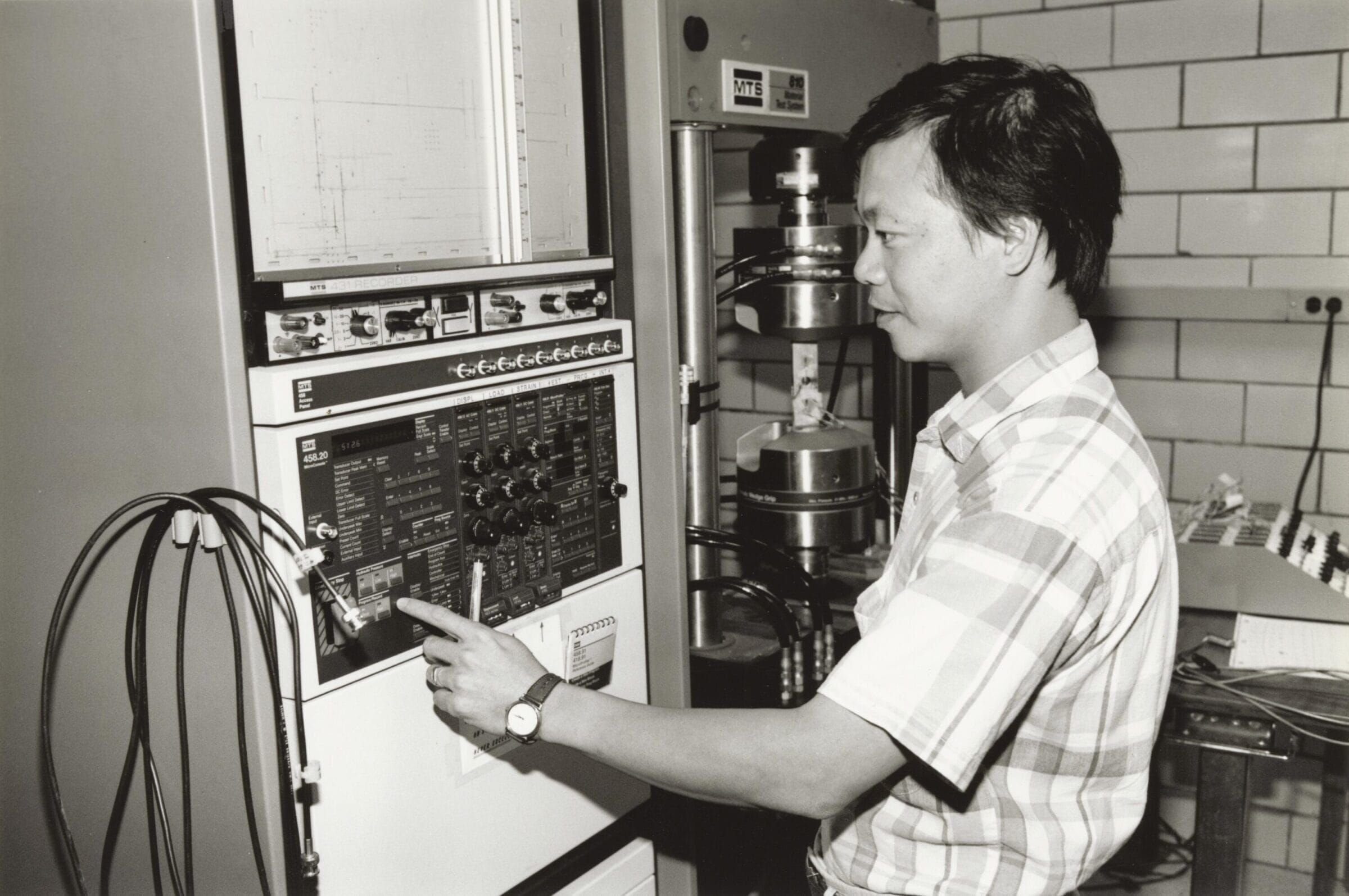 An engineering student working on a piece of equipment.