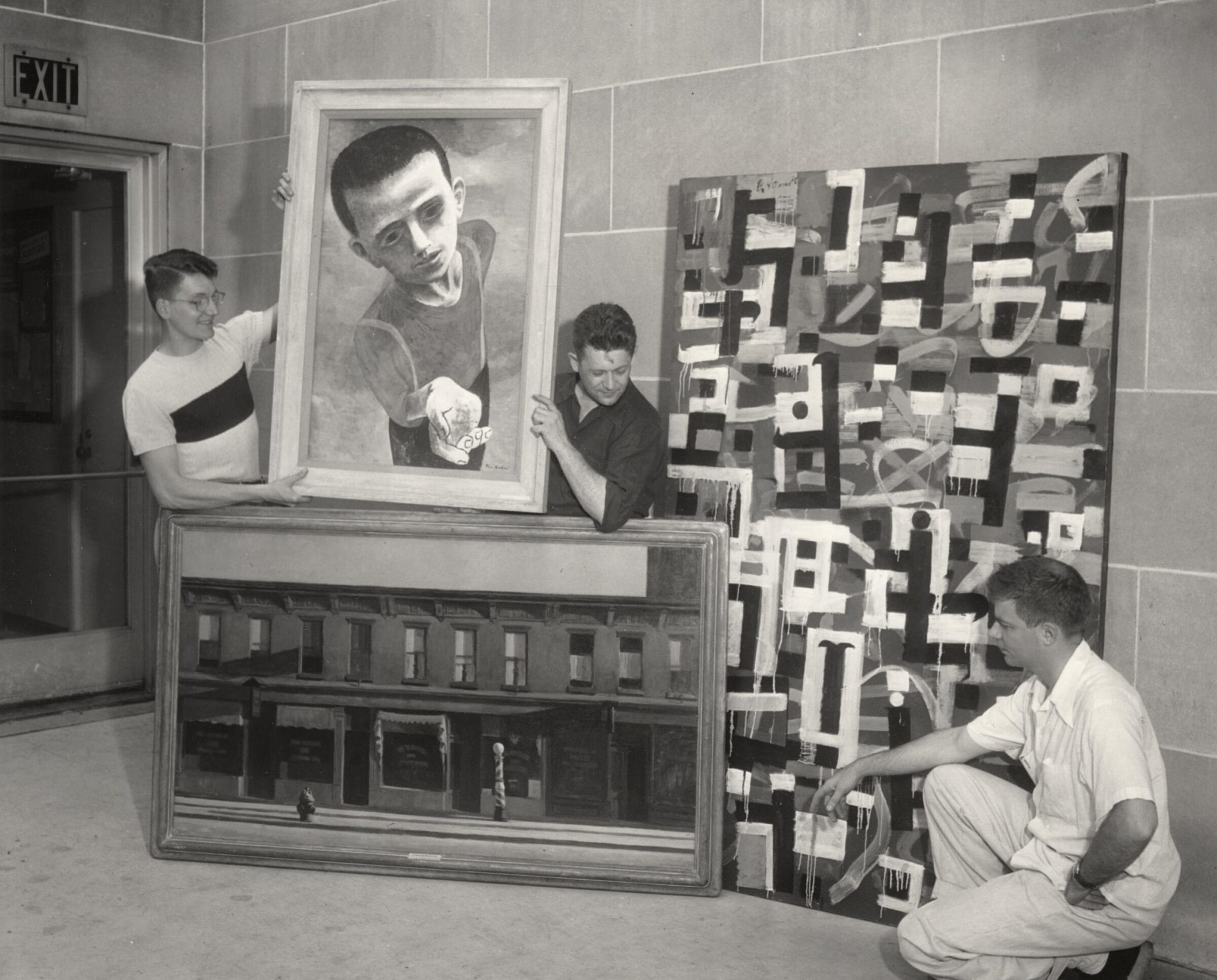 Professor Alfred Sessler (center) and Professor Robert Grilley of the Art Education Department viewing art works.